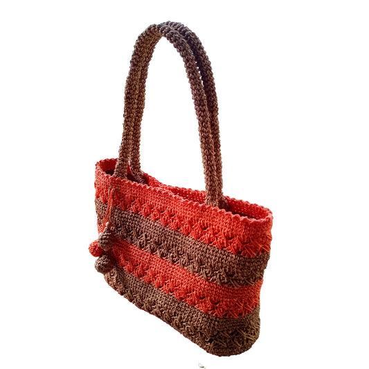 Hand made and crocheted lined, paper rope, brown and orange color tote, with swinging balls detail in front.