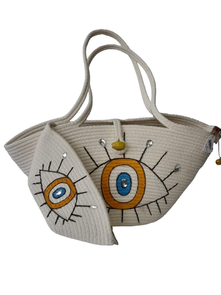 Handmade, hand painted orange evil eye protection patterned Tres double bag, shiny stone detail on both bags.