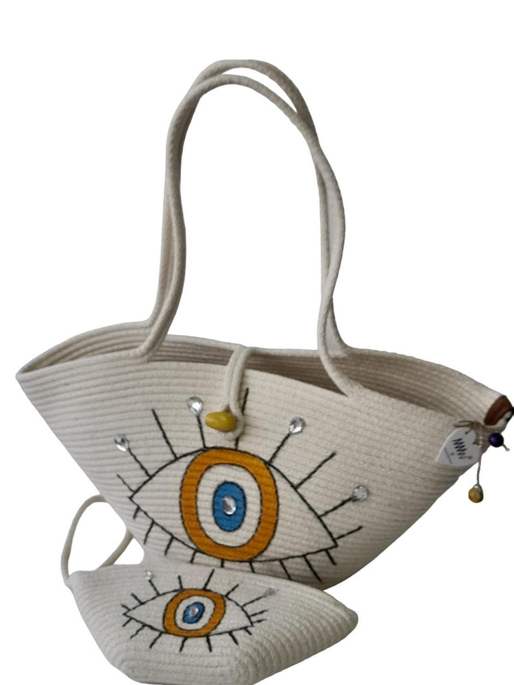 Handmade, hand painted orange evil eye protection patterned Tres double bag, shiny stone detail on both bags.