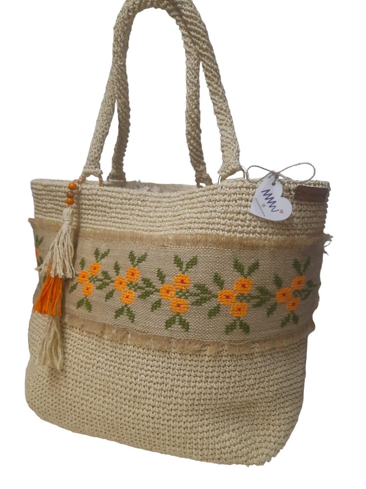 Handmade wicker large bag, with pocket detail inside, orange flowers embroidery detail with jute thread on wicker fabric around it.