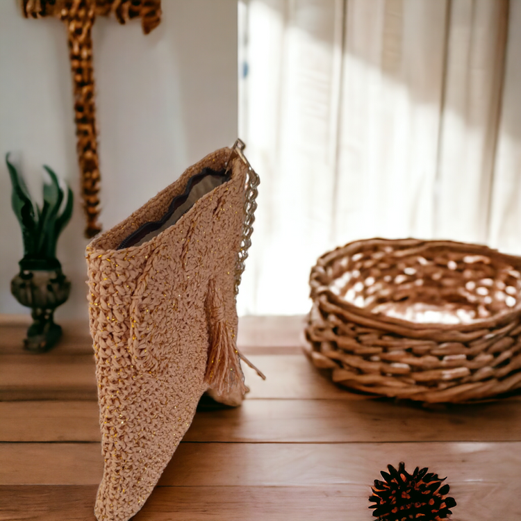 Hand crafted and crocheted wicker clutch with gold color chain strap.